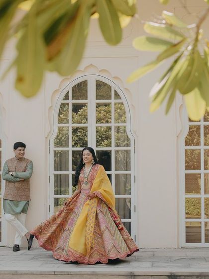 A playful and elegant shot of Tanya and Suyash at their Chandigarh destination wedding. The beautiful architecture and natural light create a perfect setting for their love story.