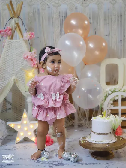 A sweet and gentle cake smash for a little princess. The soft pinks and creams of this boho setup create a beautiful backdrop for her first birthday photos.