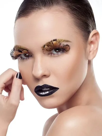 A slightly different angle of the high-fashion beauty portrait, showcasing the unique makeup artistry. The model's pose adds a touch of elegance to the bold look.