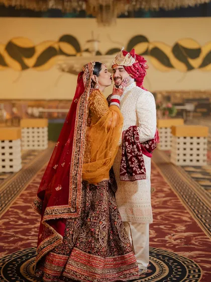 A sweet kiss for the groom! Riiya's makeup is perfectly set to last through all the emotional and happy moments of her big day.