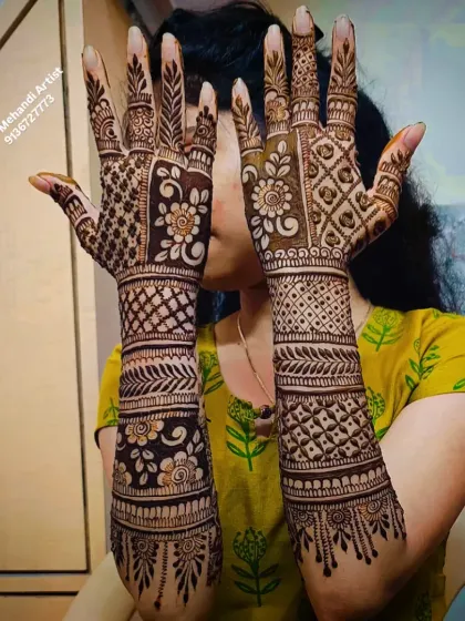 A playful pose showing off the intricate back-of-hand mehandi.