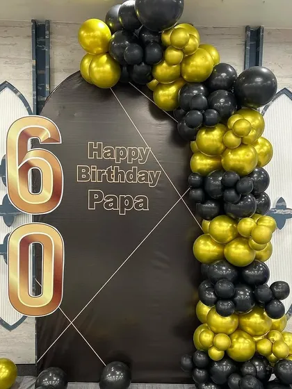 Another angle of the sophisticated black and gold 60th birthday setup.