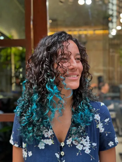 A candid shot of the client loving her new, colorful curls.