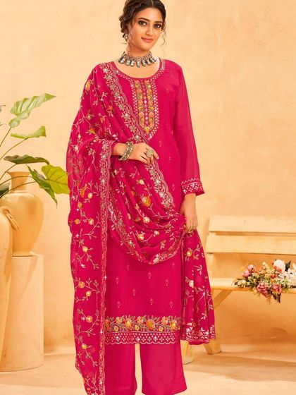 A rani pink salwar kameez that's sure to turn heads. The colorful thread embroidery and sequin work on the neckline and dupatta are just stunning.