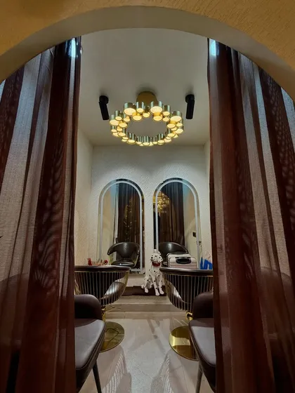 This is a peek into one of our more private sections, perfect for relaxing treatments. The elegant lighting and comfortable seating ensure a peaceful and exclusive experience for our clients.