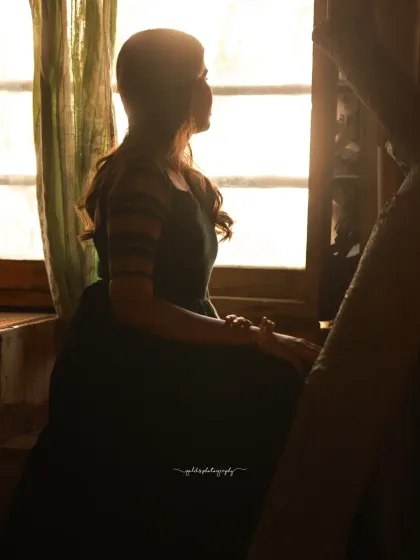 Portraits of a model in a green dress, captured in a traditional house setting. The warm, earthy tones of the location complement the outfit and create a peaceful, grounded mood.