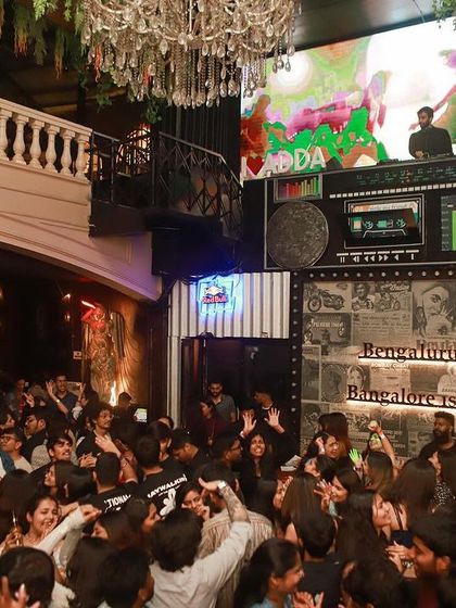 Another angle showing the crowd packed in below the massive LED screen.