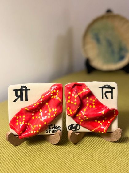 A set of custom ceramic tiles created to capture a shared memory between friends involving a red bandhani dupatta. This project was a fun challenge, from finding the right way to depict the fabric's drape to painting its delicate pattern.