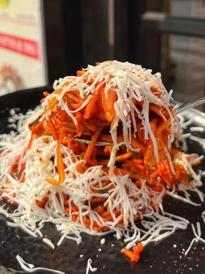 A forkful of my Cheese Chinese Bhel, showing the crunchy noodles and melted cheese. It's a snack you won't be able to resist.