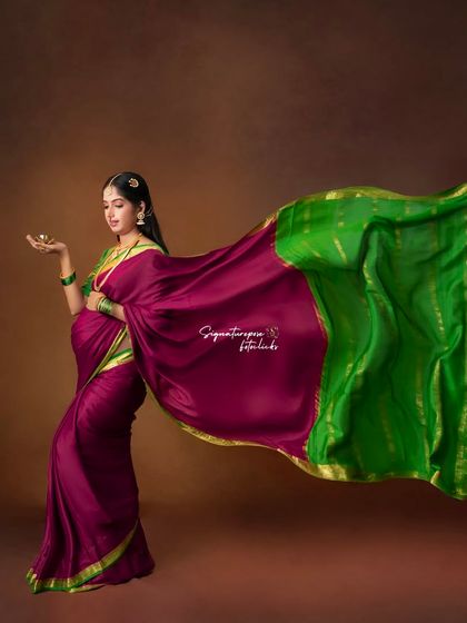 The flowing saree creates a sense of movement and grace in this beautifully composed traditional maternity portrait.