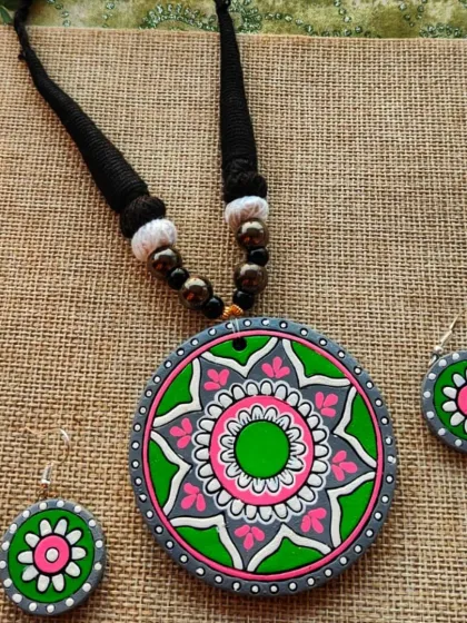 The same mandala pendant necklace, here in a cool green, pink, and gray color scheme.