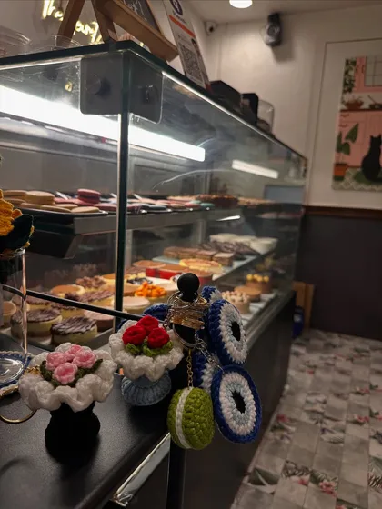 Some of my keychains, including the evil eye and mini bouquets, enjoying a day out at a cafe.