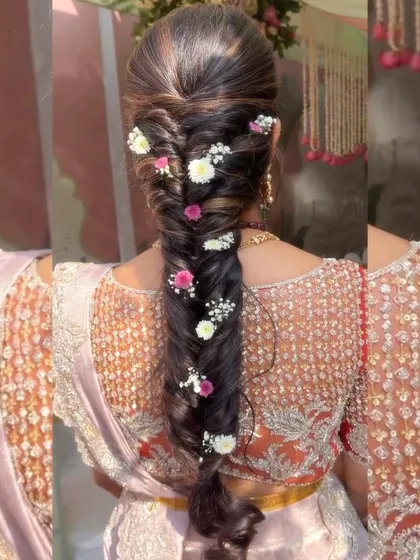 A beautiful fishtail braid adorned with fresh pink and white flowers. This is a perfect hairstyle for a daytime wedding or mehendi ceremony.