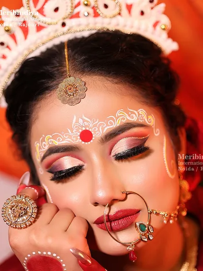I will teach you the art of traditional Bengali bridal makeup, focusing on the iconic large, expressive eyes and the intricate 'Chandan' designs on the forehead that are central to this beautiful cultural look.