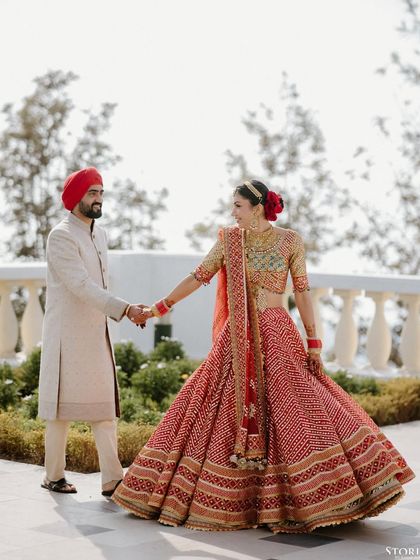 Rohit and Mehak sharing a dance, her vibrant bandhani lehenga creating a beautiful swirl of color.