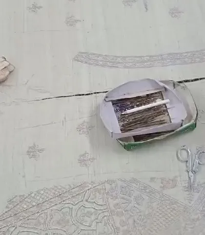 The artisan's table, where threads, scissors, and patterns come together. This is where the magic of hand-embroidery begins, stitch by meticulous stitch.