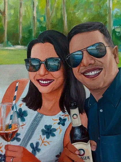 A close-up of the couple's portrait, showing the detail in their smiles and the lush, green background.