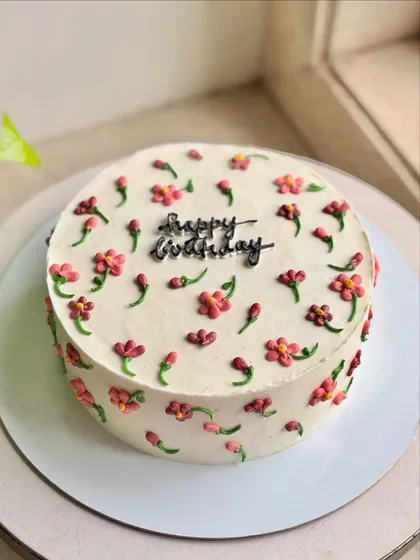 Minimal blooms, maximum charm. This cake is covered in tiny, hand-piped pink and red flowers for a delicate and pretty birthday celebration.