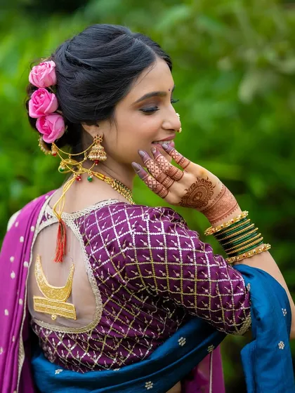 A closer look at the elegant floral bun and the custom blouse with a chandrakor motif. I believe hairstyling is just as crucial as makeup in completing the bridal vision.