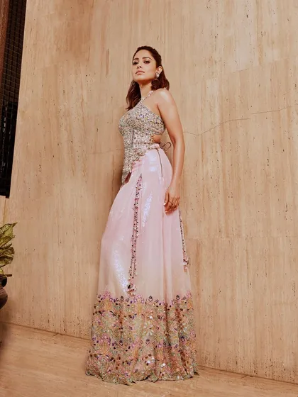 This pastel pink lehenga with intricate floral embroidery is a beautiful choice for a daytime event. I styled this look on Nushrratt Bharuccha for a soft, romantic, and elegant vibe.