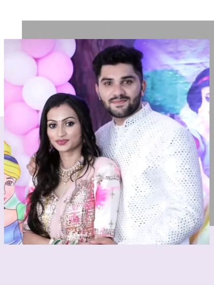 This couple shows how to coordinate with subtle elegance. Her light pink and floral lehenga is a beautiful match for his white mirror-work Indo-Western outfit.