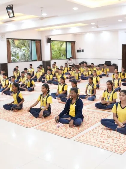 We bring Yoga to diverse groups, including students in different uniforms, reflecting our mission to create a unified community through wellness.