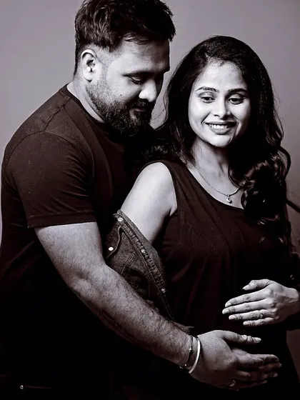 Sometimes the most powerful portraits are the simplest. This intimate black and white studio shot focuses purely on the connection and anticipation you share as a couple.