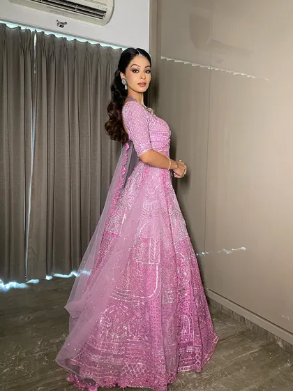 The magic of minimal grandeur. This model shoot showcases a modern Sangeet look in a lilac lehenga, featuring clean makeup and glossy lips for an edgy yet classy vibe.