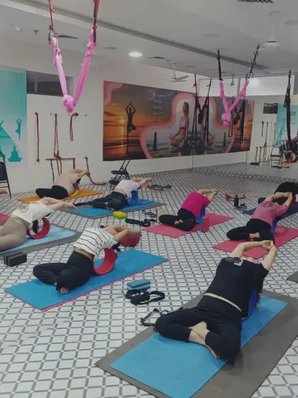 In my studio, we use various props to deepen our practice. This class is using yoga wheels and blocks for a supported backbend, which helps open the chest and spine safely. It shows how we can modify poses to suit individual needs.