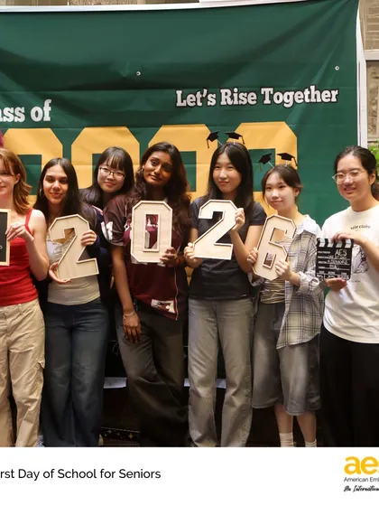A group of senior girls holds up signs for their graduating year, '2026'. Marking these milestones helps students reflect on their journey and look forward to the future.