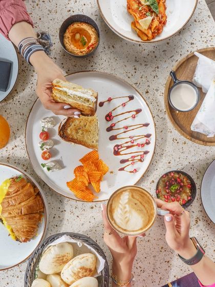 A top down view of a full table spread at Cafe Zima. This kind of shot is great for showing the variety of a menu and creating a feeling of a shared, social dining experience.