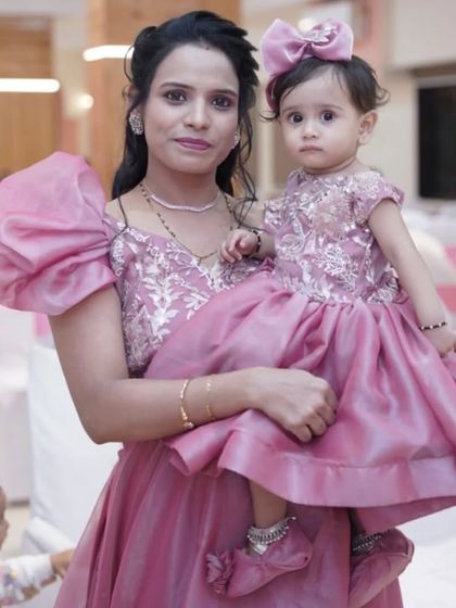 This mother-daughter combo in dusty pink is perfect for birthdays and family functions. The dress features elegant puff sleeves for the mother and a matching adorable frock for the daughter.