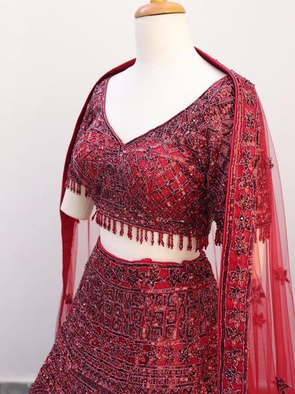 A close-up of a maroon sequined lehenga blouse. The detailed beadwork and rich color make it a perfect choice for a glamorous evening function.