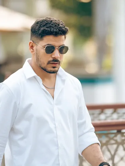 A sharp, confident portrait featuring sunglasses from Shisen Fox. The urban background and direct gaze create a powerful image that sells a lifestyle, not just a product.