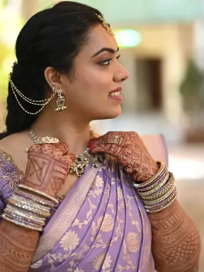 A close-up on the details. The intricate jewelry, henna, and the soft makeup come together to create a stunning and complete bridal look.