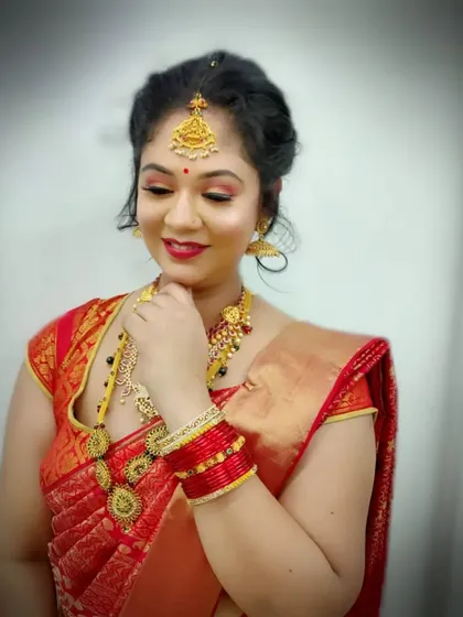 A beautiful example of a South Indian bridal look, featuring warm, glowing makeup with a classic red lip. Our students learn to perfect this style, which is always in high demand.