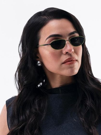 A portrait of Gaure Monga for the Lenskart campaign, showcasing a pair of chic, oval sunglasses.