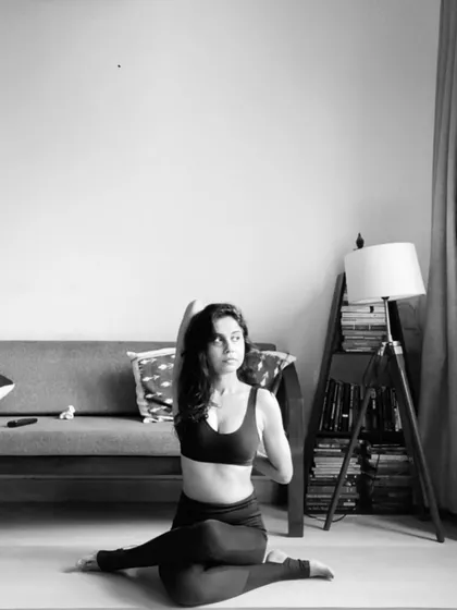 A quiet moment in Gomukhasana, or Cow Face Pose. This asana provides a deep stretch for the hips, shoulders, and arms simultaneously.