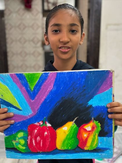 This still life of peppers by a 6th-grade student is another great example of how we explore colour and form. The dark, expressive background makes the vibrant vegetables stand out.