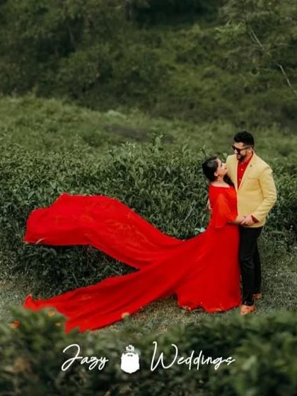 A vibrant pre-wedding shoot in a tea garden. The client's red flying gown and her partner's yellow blazer create a unique and eye-catching color combination.
