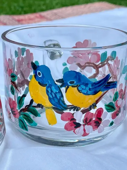 A set of low, wide glass cups with a cherry blossom and bluebird design, perfect for green tea or coffee.