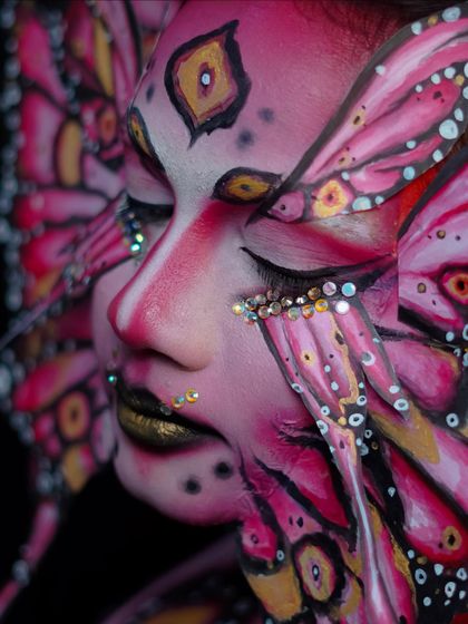 A close-up on the sparkling gems and detailed line work that make this fantasy makeup so special.