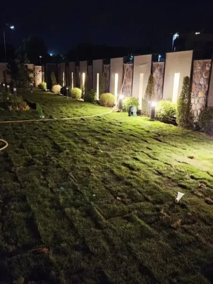 The lawn area midway through the installation process, showing the grid-like pattern of freshly laid turf rolls. This demonstrates the systematic approach we take to ensure even and complete coverage for a flawless finish.