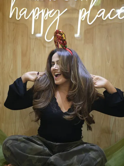A joyful hair flip! This candid moment captures the happiness and confidence that comes with a fresh, fabulous hairstyle.