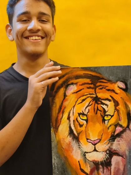 A student proudly displays his powerful tiger painting, created entirely with a palette knife. This piece showcases how to build form and intensity through textured layers of paint.