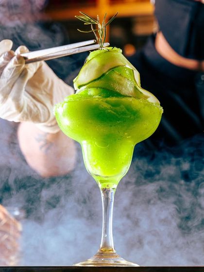We believe the overall experience is as important as the food. This dramatic, smoky green cocktail is a perfect example of how we create a feast for all the senses.