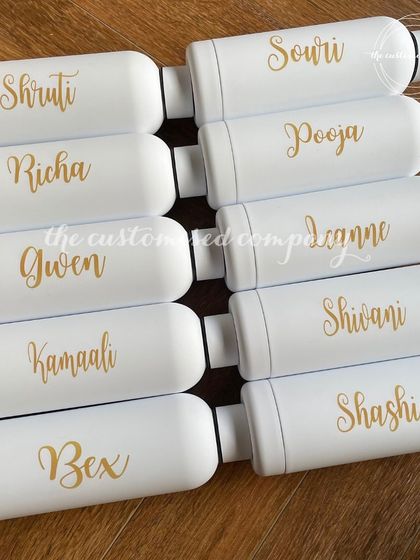 In a world of ordinary, choose something extraordinary. These sleek white insulated bottles are personalized with names in a beautiful gold script, making them a perfect gift for a group.