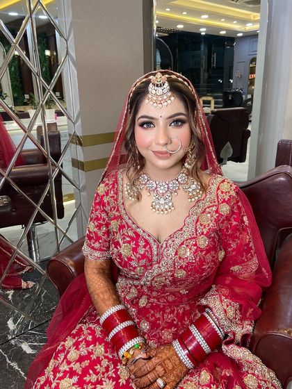 Self-love is the foundation of bridal beauty. This bride looks absolutely radiant and confident in her classic red lehenga and soft glam makeup.