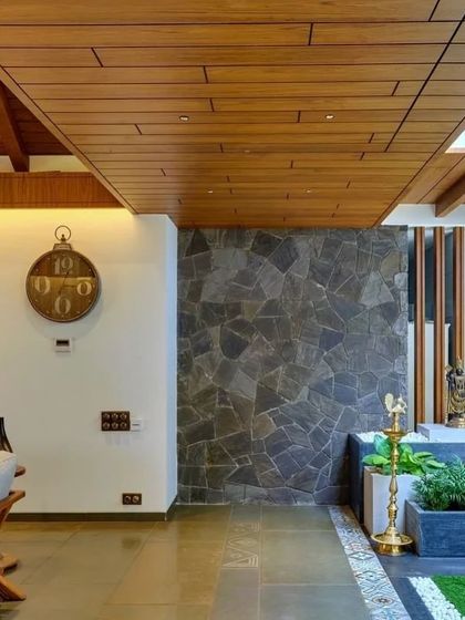 An interior courtyard with a stone planter and traditional lamp, demonstrating how heritage elements are integrated into the contemporary design.