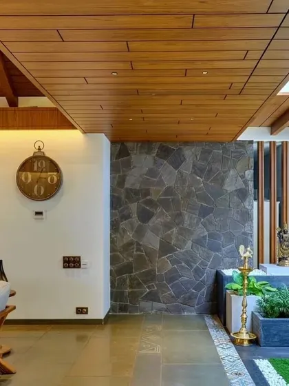 An interior courtyard with a stone planter and traditional lamp, demonstrating how heritage elements are integrated into the contemporary design.